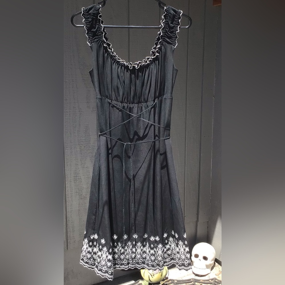Beautiful tank top style dress with embroidered bottom hem.